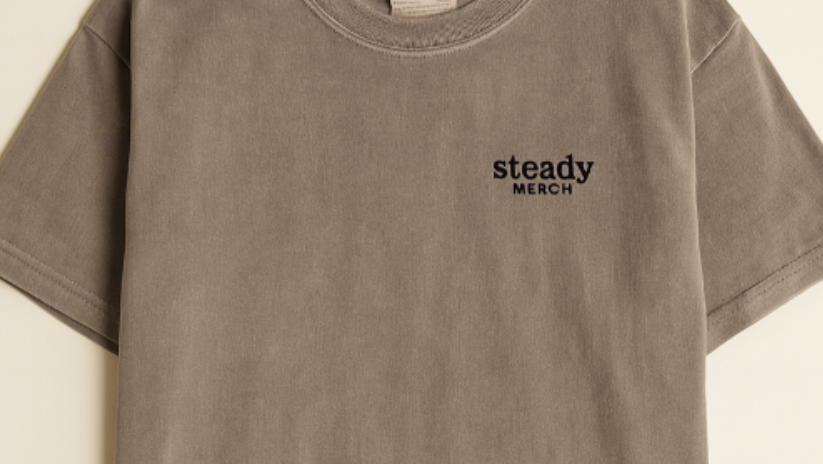 brown t-shirt with steady merch screenprinted on the left chest